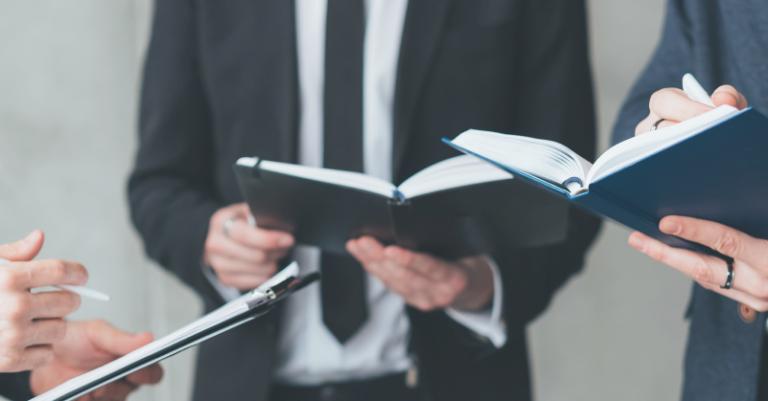 Photo: a group of people in business wear making notes