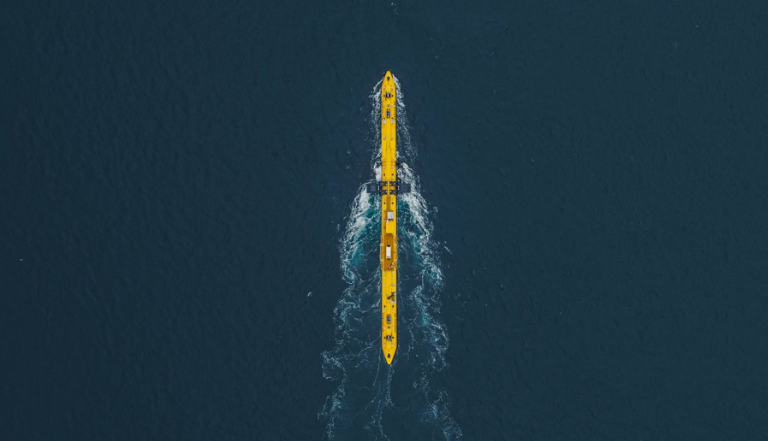 yellow tidal wave energy station surrounded by deep blue water